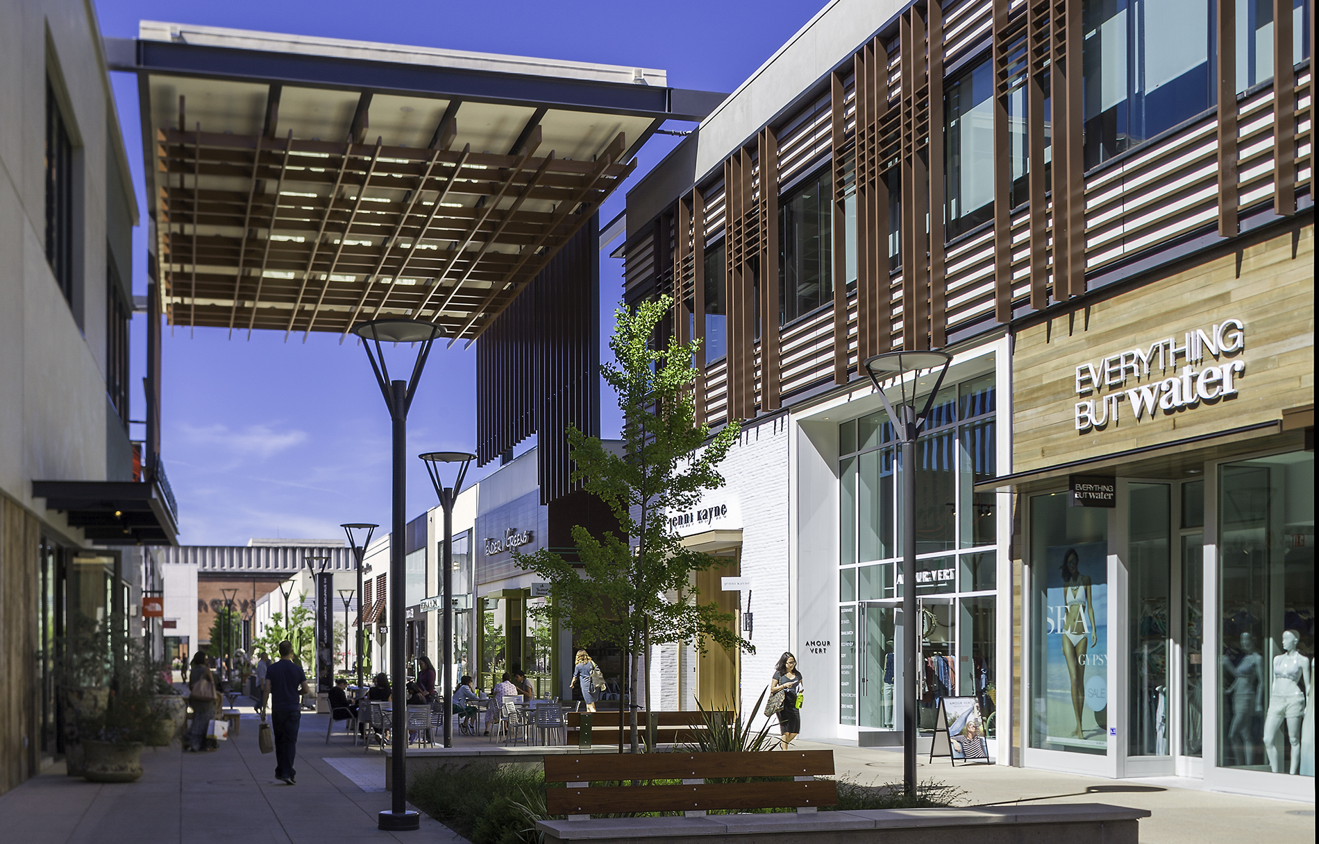 Shoppers stroll through the upscale, open-air Stanford Shopping Center in Menlo Park on a sunny day.