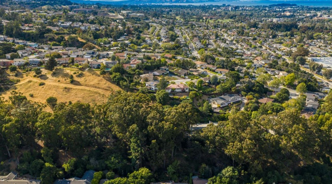 Aerial view of Laurelwood neighborhood San Mateo showing hillside homes, mature trees, and natural landscape integration