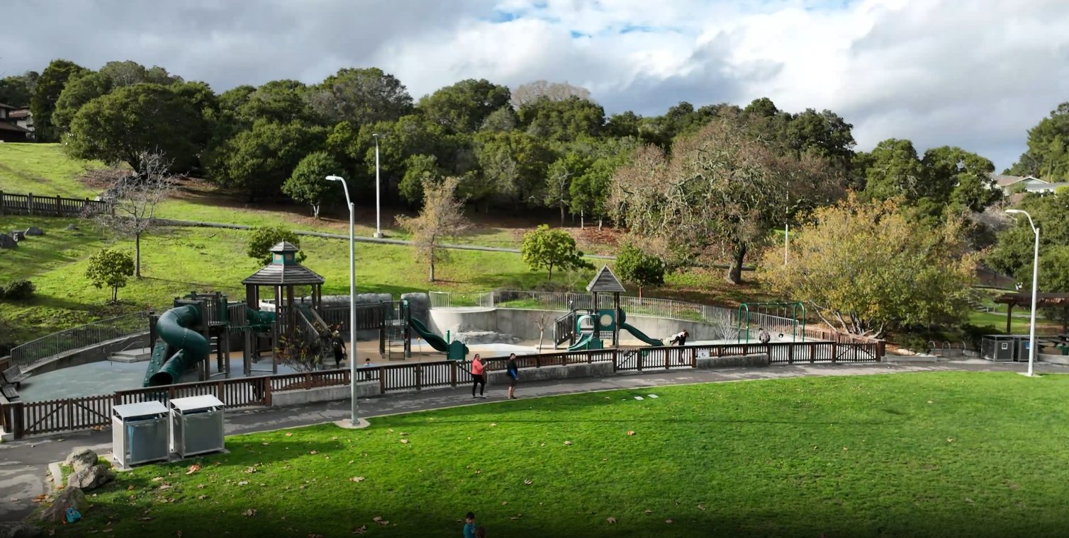 Laurelwood Park playground and open green space in Sugarloaf San Mateo neighborhood showing 225-acre protected parkland with families enjoying recreational facilities