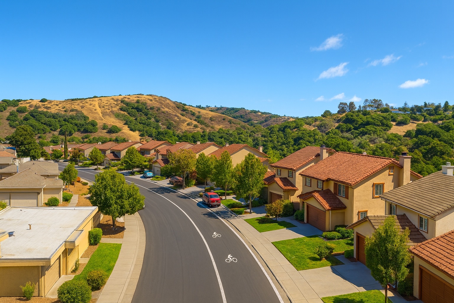 Laurelwood neighborhood San Mateo street view showing Spanish Colonial Revival homes with red tile roofs against golden California hills